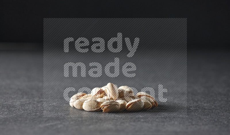 A bunch of pistachios on a black background in different angles