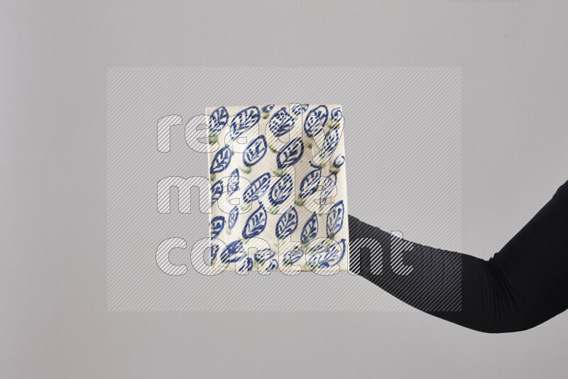 A woman in black abaya holding different pottery essentials in different positions