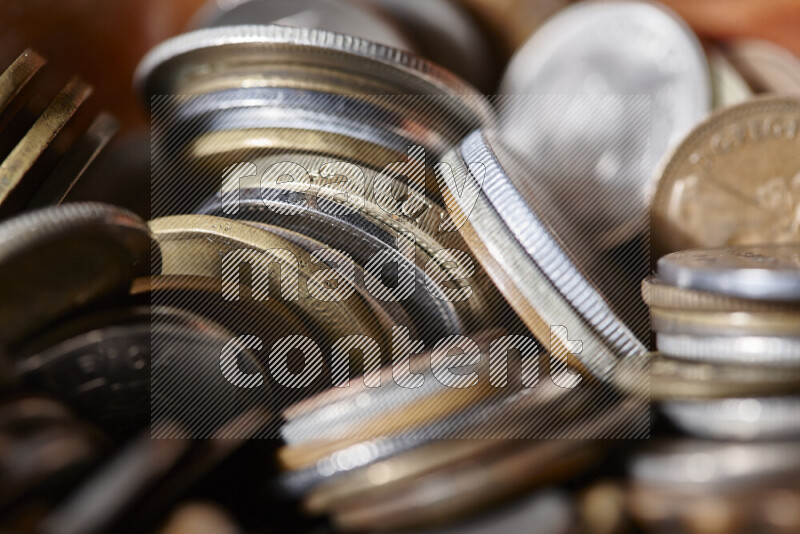 A close-ups of random old coins on black background