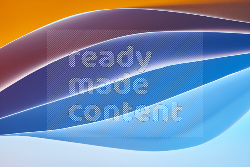 This image showcases an abstract paper art composition with paper curves in blue and orange gradients created by colored light