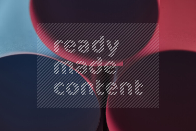 The image shows an abstract paper art with circular shapes in varying shades of blue and red