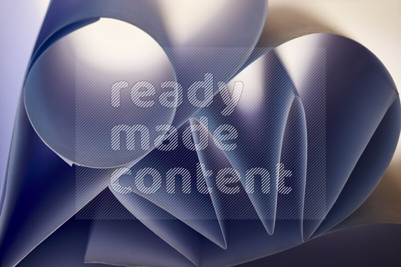 An artistic display of paper folds creating a harmonious blend of geometric shapes, highlighted by soft lighting in blue tones