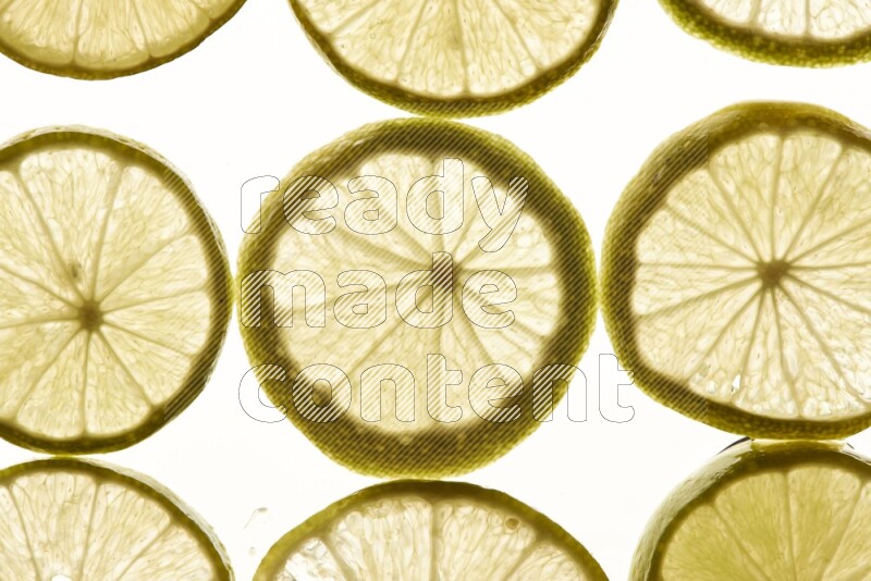 Lemon slices on illuminated white background