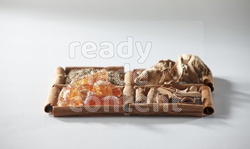 4 squares of cinnamon sticks full of cumin, cinnamon, dried ginger and gum arabic on white flooring
