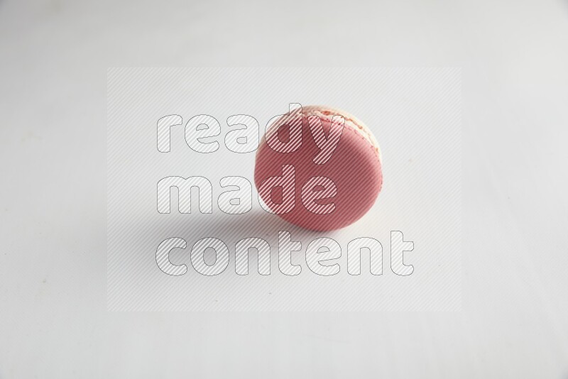 45º Shot of Pink Litchi Raspberry macaron on white background
