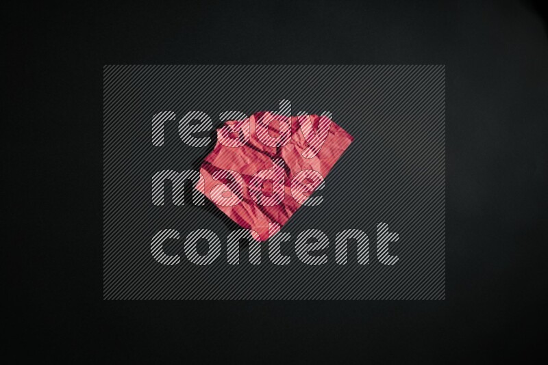 Crumpled multicolored paper on black background