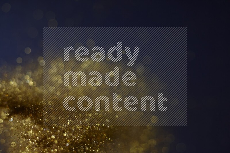 Gold glitter powder isolated on black background