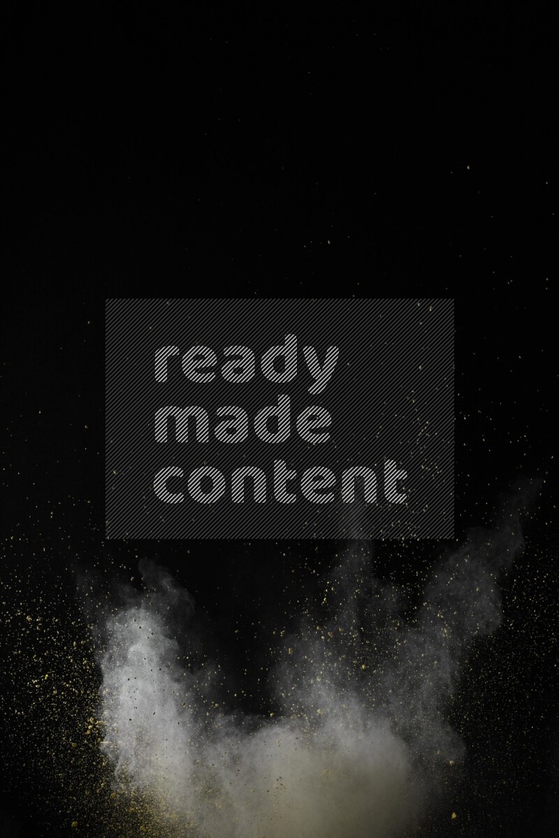 A side view of yellow powder explosion on black background