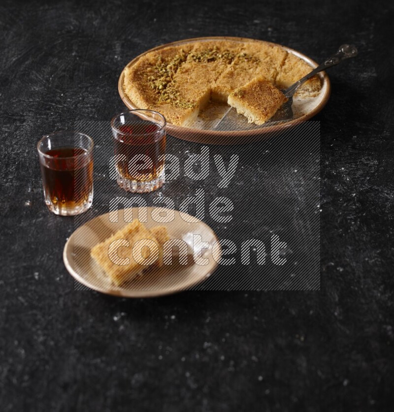 konafa with tea in a dark setup