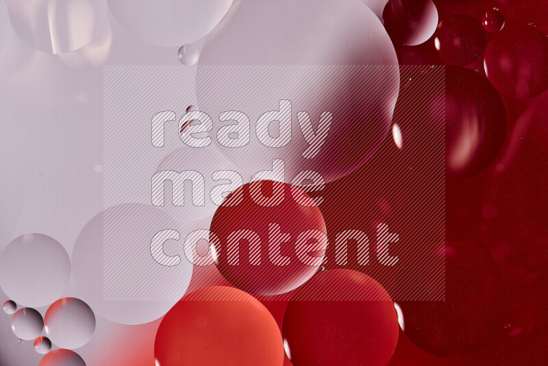 Close-ups of abstract oil bubbles on water surface in shades of white and red