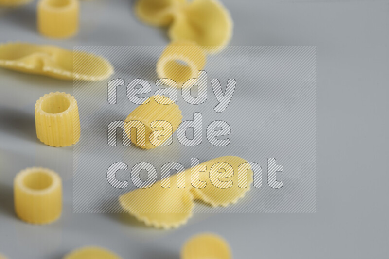 Different pasta types on light blue background