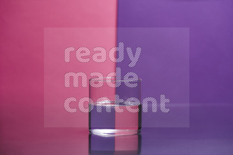 The image features a clear glassware filled with water set against pink and purple background