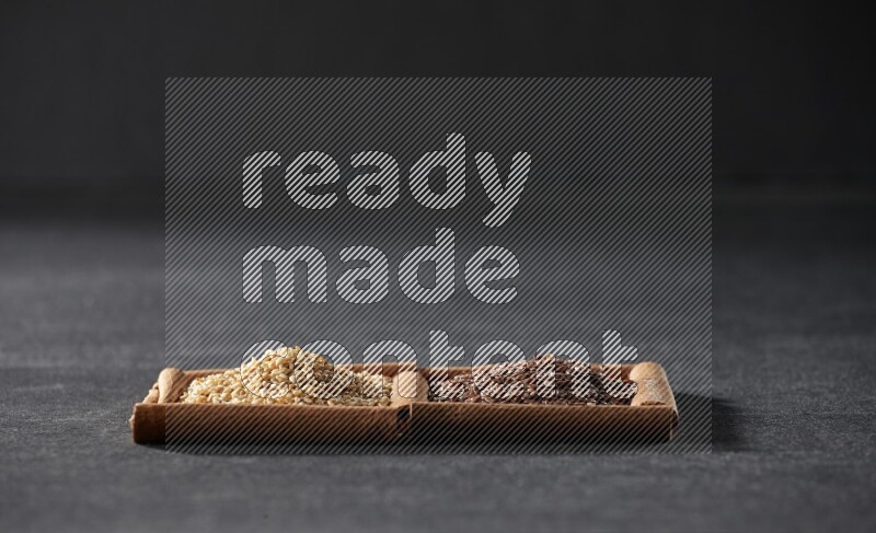 2 squares of cinnamon sticks full of flaxseeds and sesame on black flooring