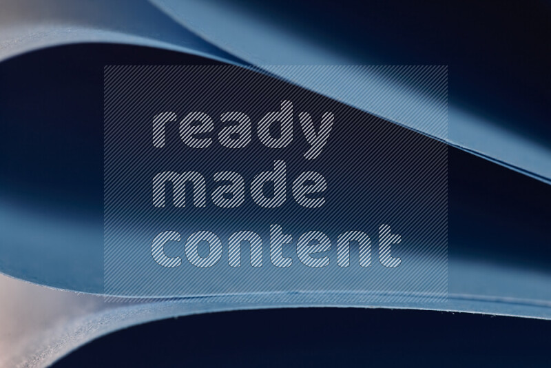 An abstract art showing blue paper sheets arranged in an overlapping curves
