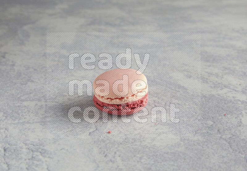 45º Shot of Pink Litchi Raspberry macaron on white  marble background
