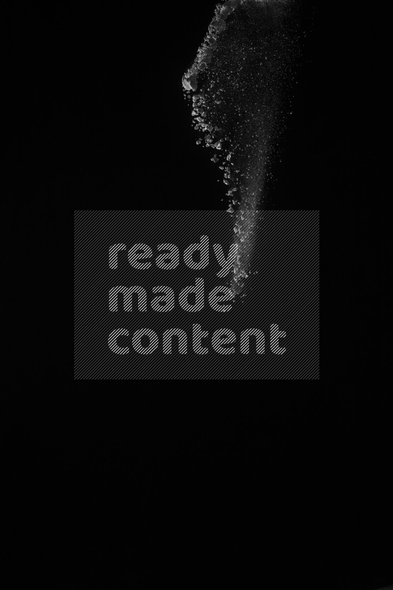 A side view of white powder explosion on black background