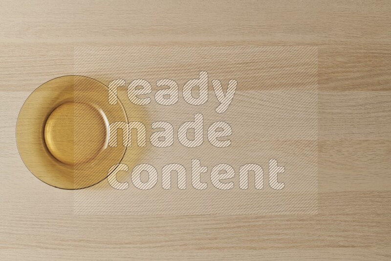 A circular glass plate on light wooden background