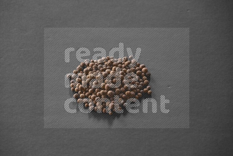 Allspice on a black flooring