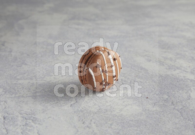 45º Shot of Brown white Chocolate Caramel macaron on white  marble background
