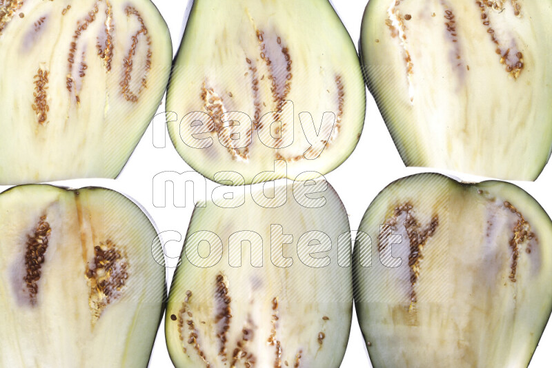 Eggplant slices on illuminated white background