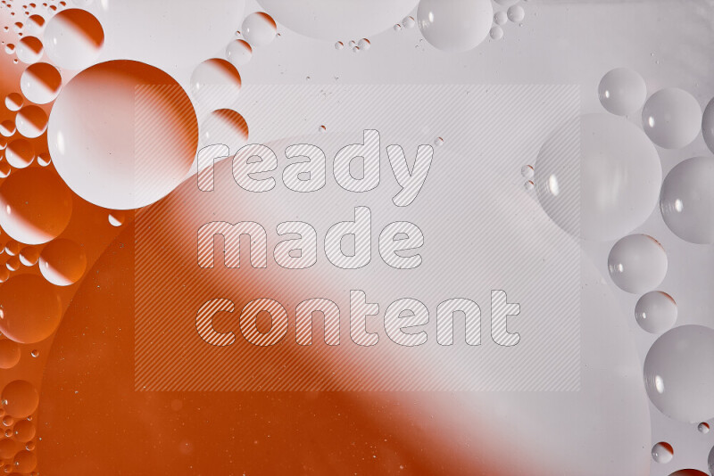 Close-ups of abstract oil bubbles on water surface in shades of white and orange
