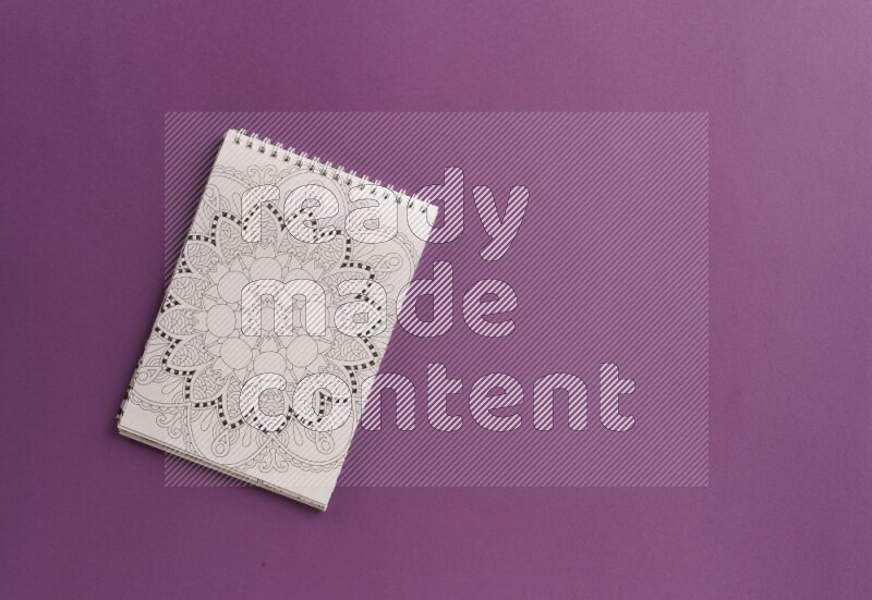 A coloring book with coloring pens on purple background