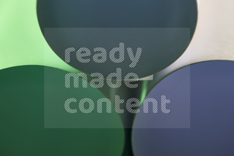 The image shows an abstract paper art with circular shapes in varying shades of green