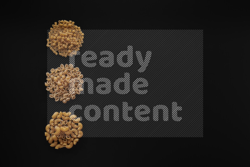 Different pasta types in 3 bunches on black background