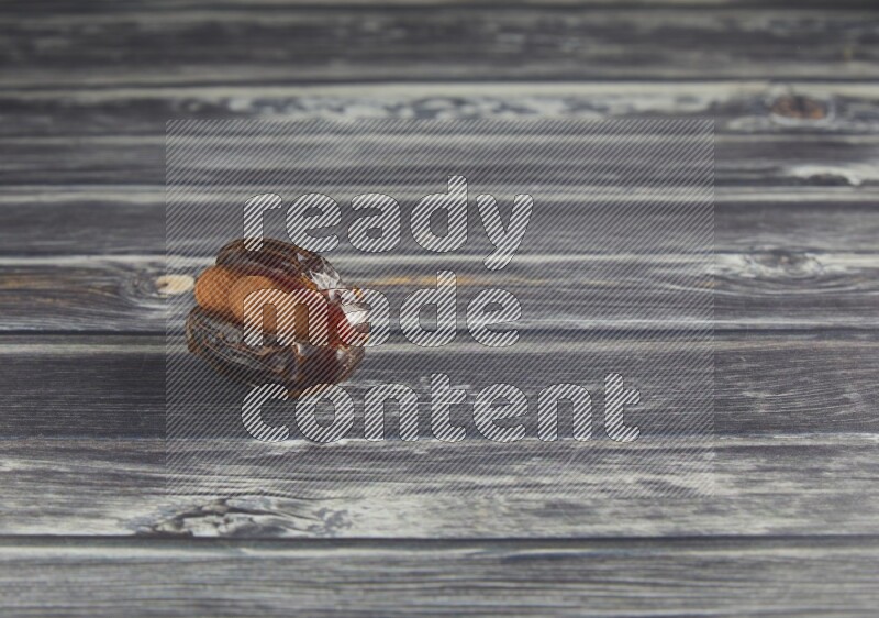 almond stuffed madjoul date on a wooden grey background
