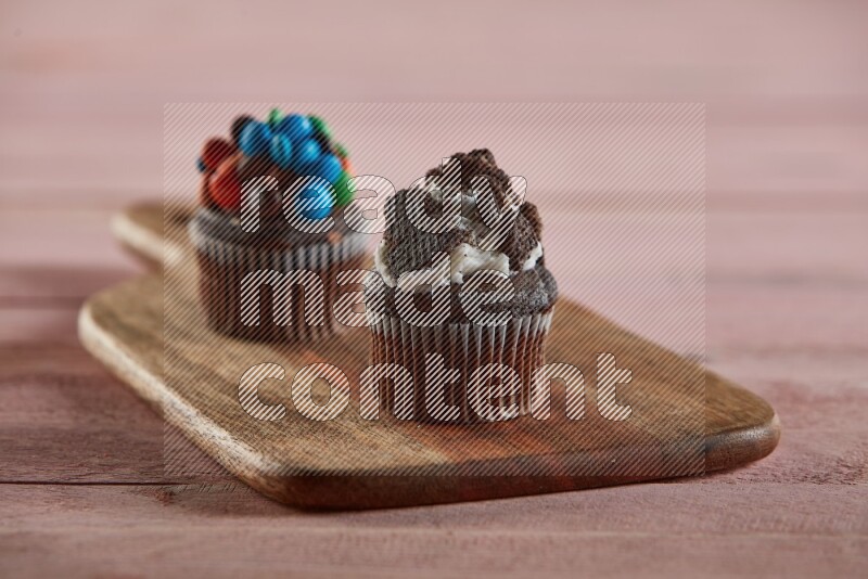 Chocolate mini cupcake topped with oreo on a wooden board