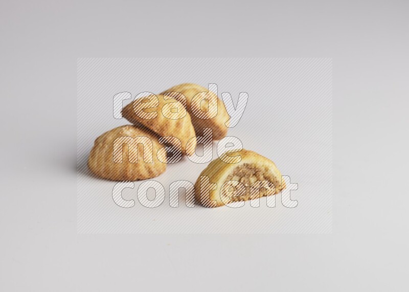 Four Pieces of Maamoul filled with walnut paste  one of them is cut direct on white background