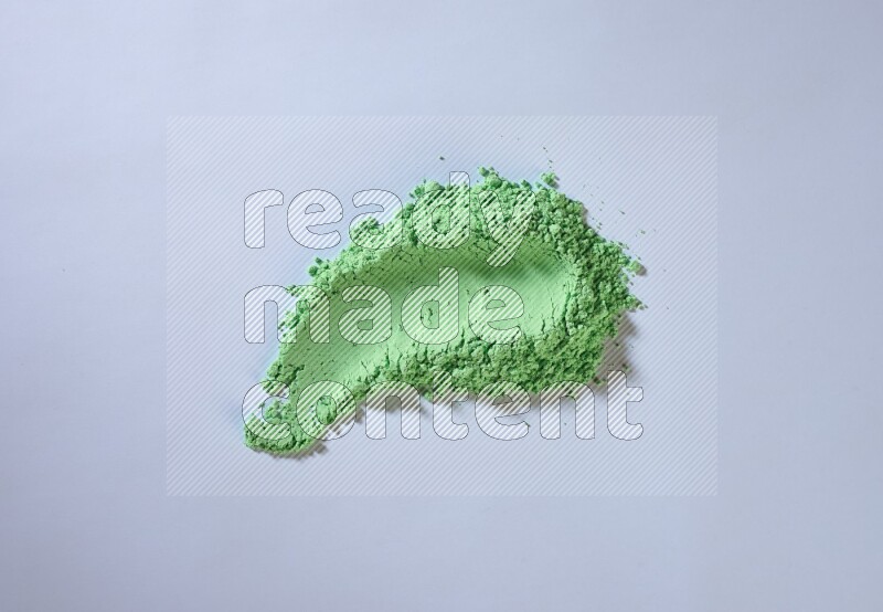 Green powder smears on white background