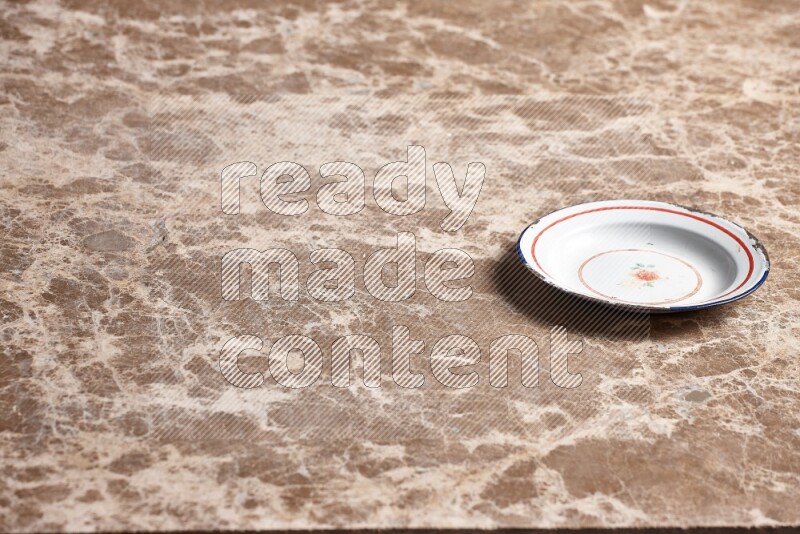 A vintage metal plate on beige marble background