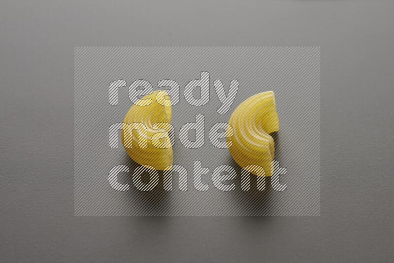 Elbow pasta on grey background
