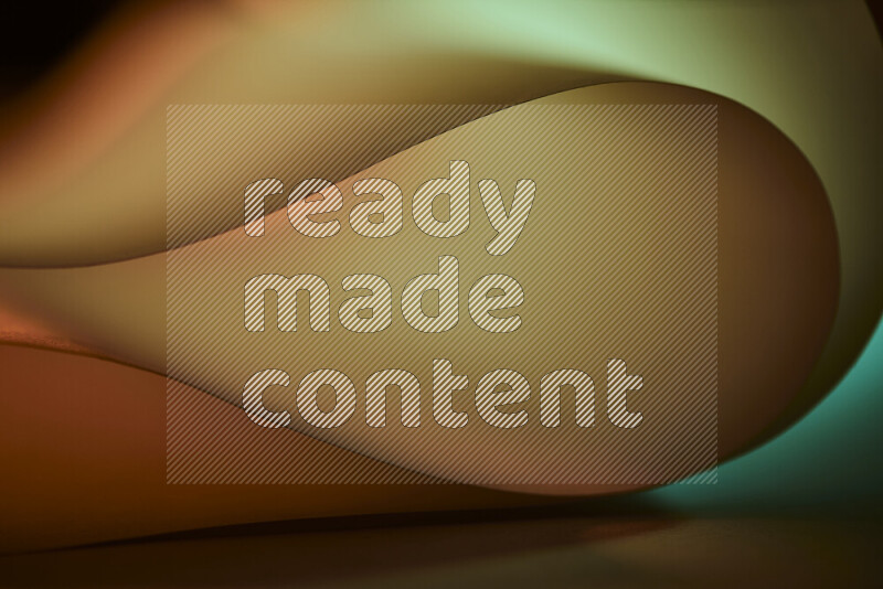 An abstract art piece displaying smooth curves in yellow and green gradients created by colored light