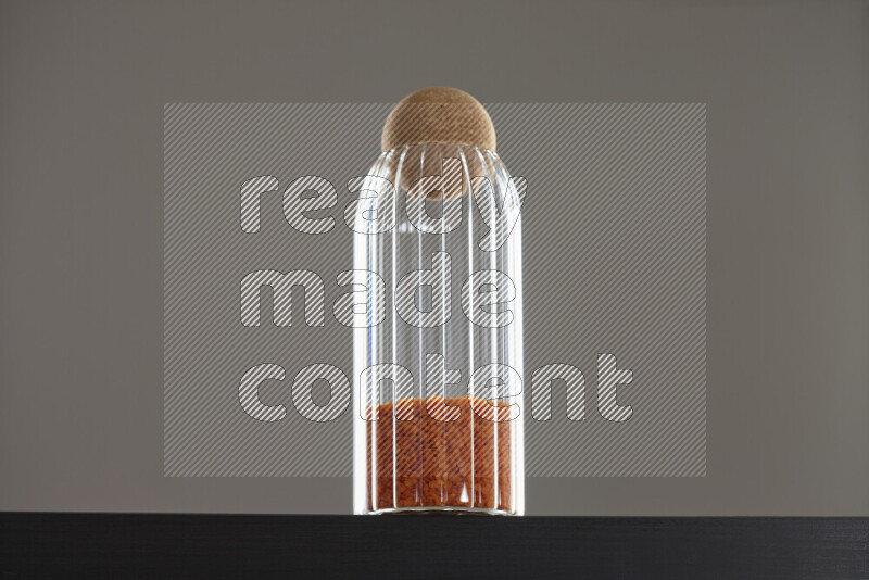 Lentils in a glass jar on black background