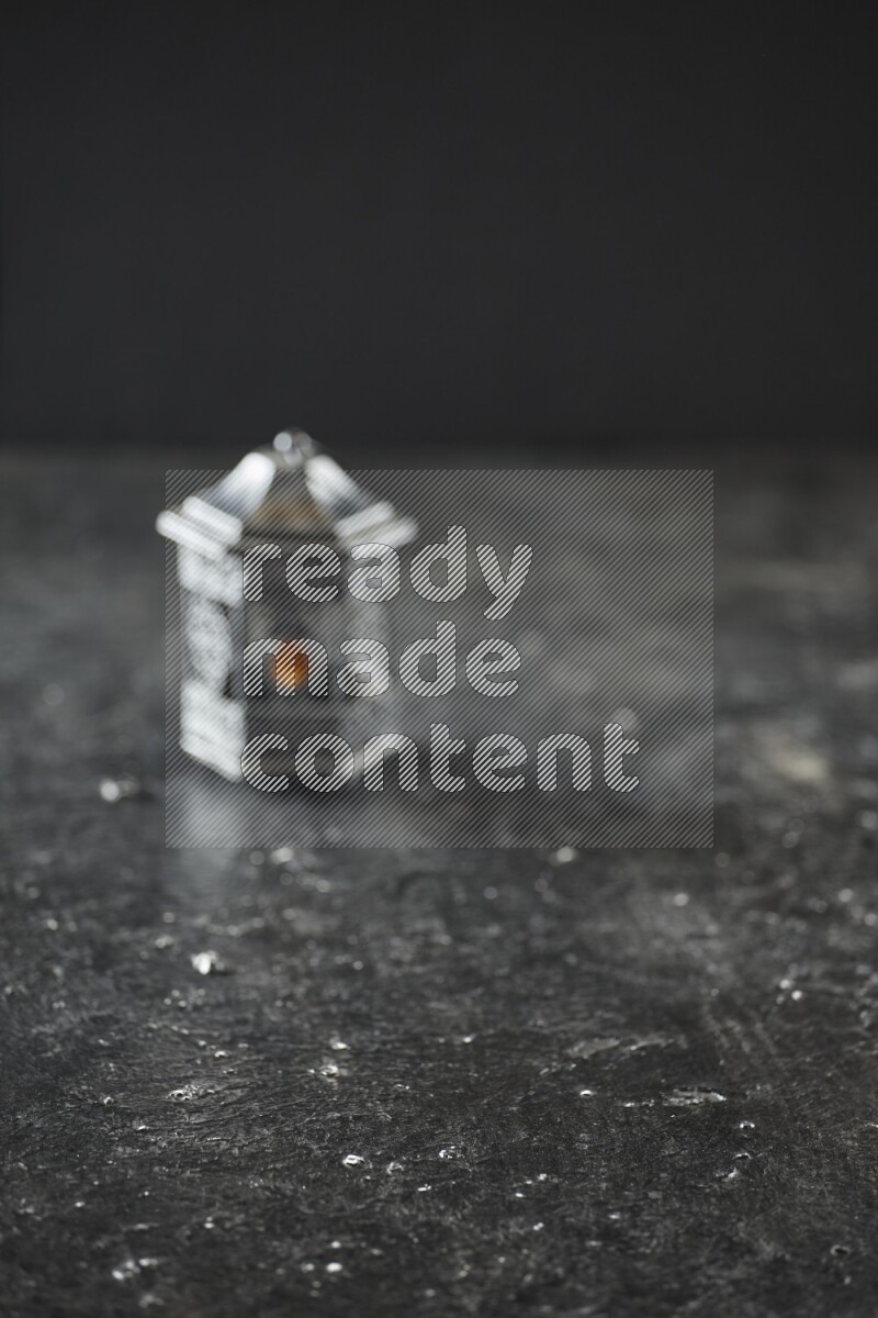 An out of focus lantern on textured black background