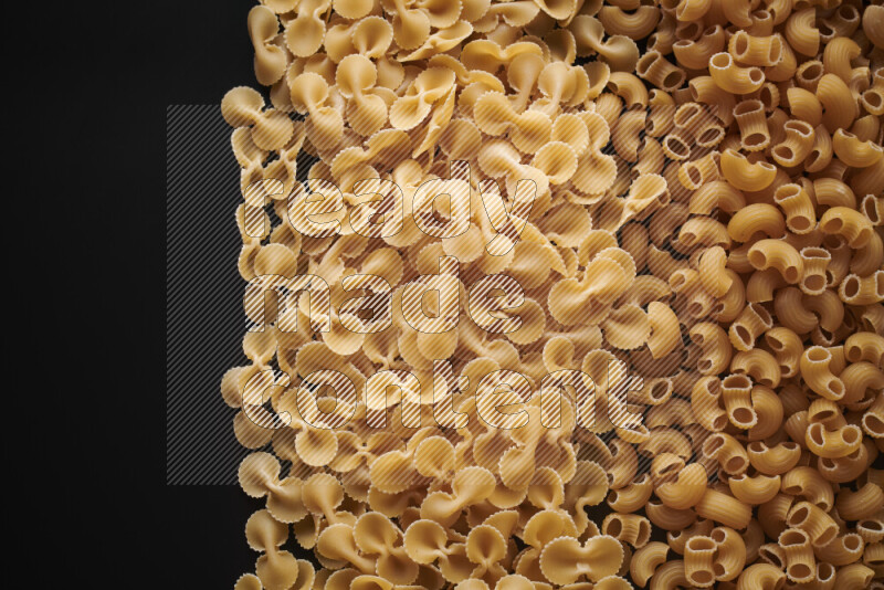 Different pasta types on black background