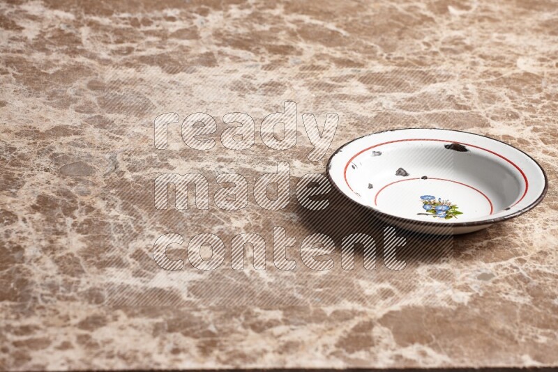 A vintage metal plate on beige marble background