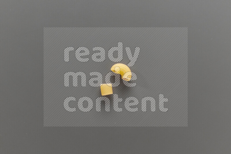 Big rings pasta with other types of pasta on grey background