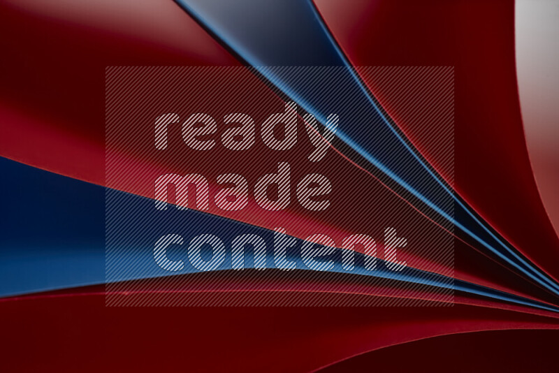 An abstract art showing red and blue paper sheets arranged in an overlapping curves