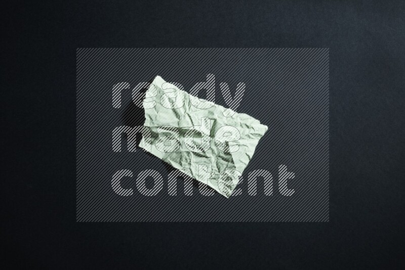 Green paper sheet on black background