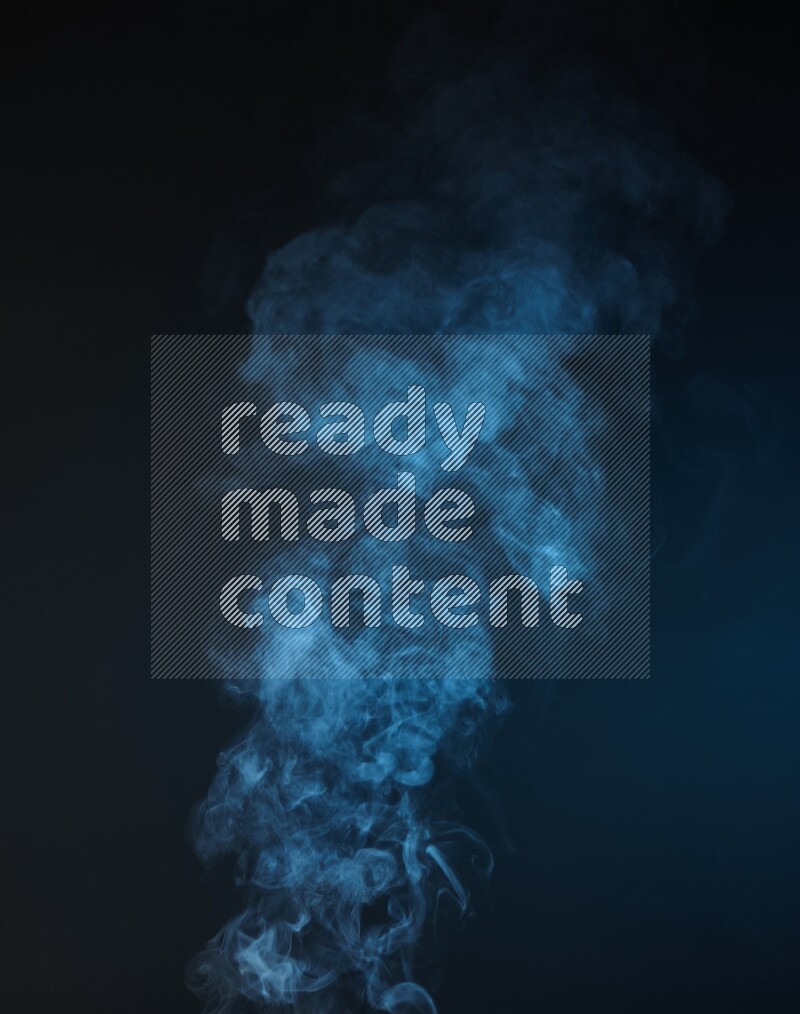 Heavy smoke in blue isolated on black background