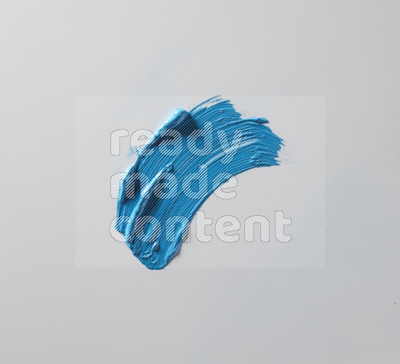 A single blue curved brush stroke on a white background