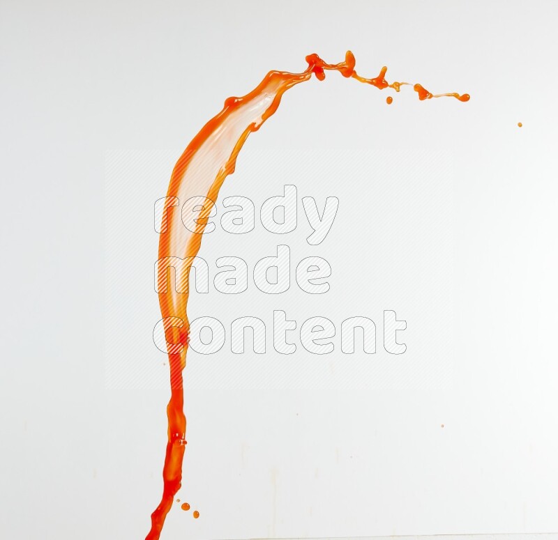 Orange liquid splash and drops on white background
