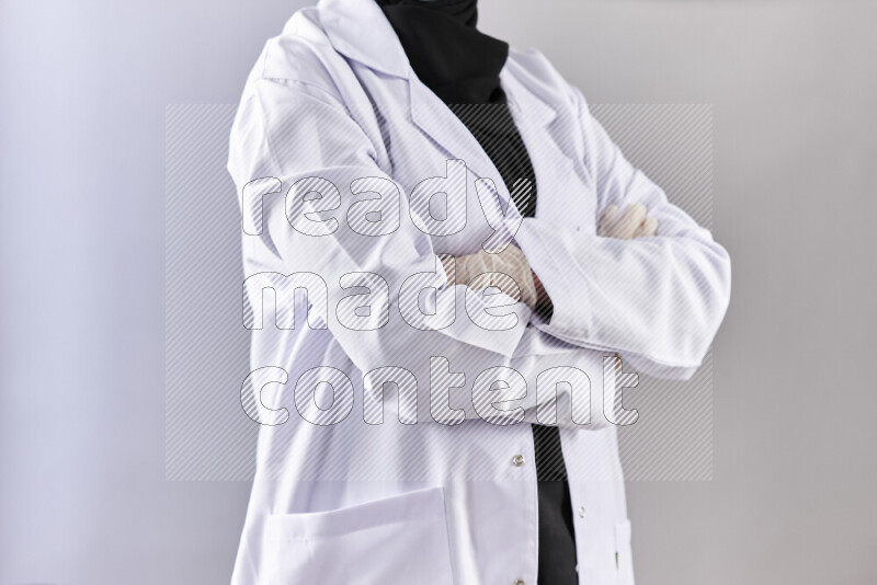 Female doctor wearing an abaya and medical attire in different positions