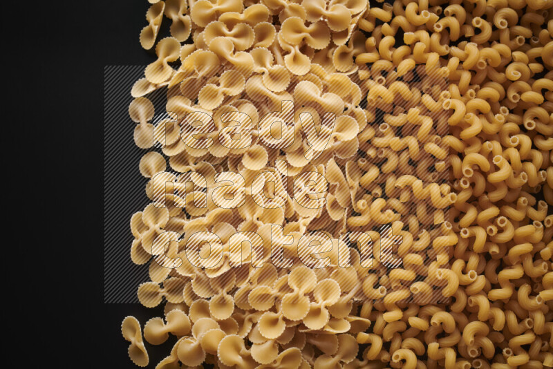 Different pasta types on black background