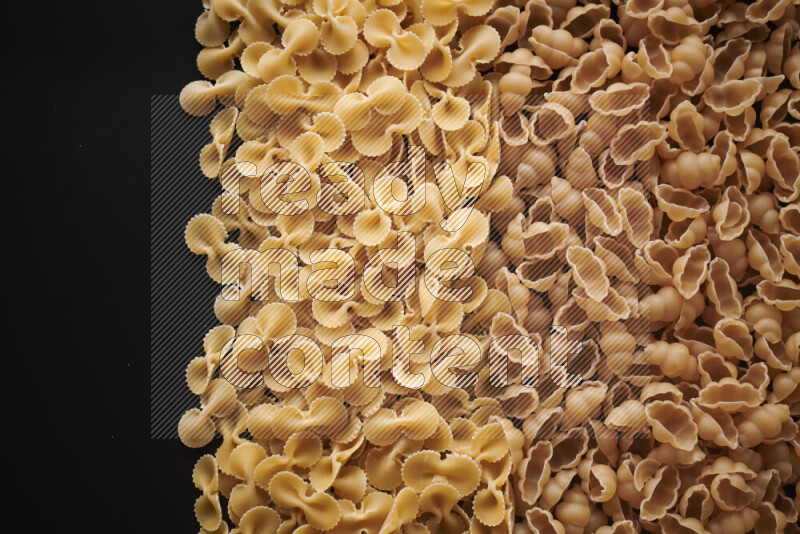 Different pasta types on black background