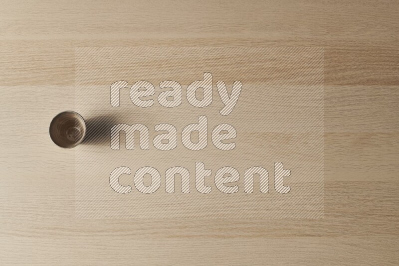 A pottery cup on light wooden background