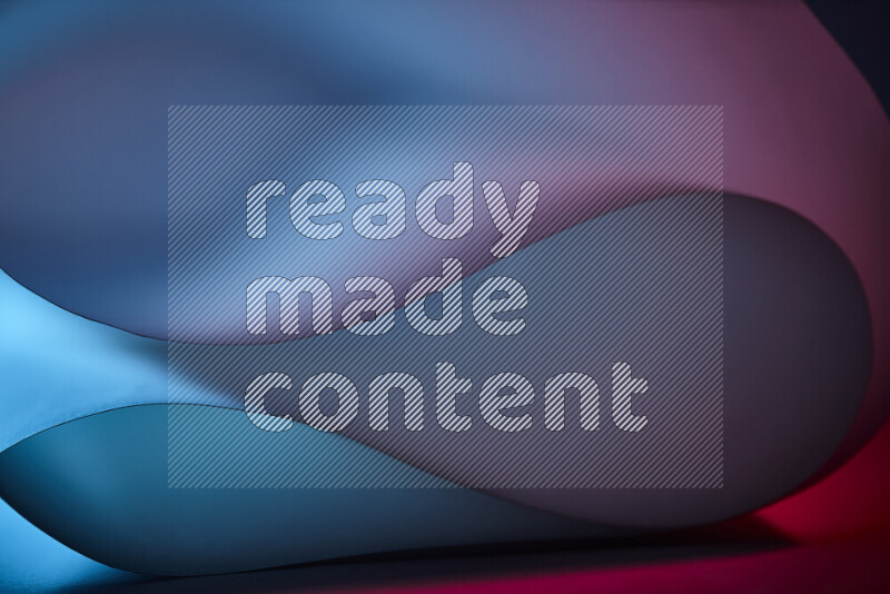 An abstract art piece displaying smooth curves in blue and red gradients created by colored light